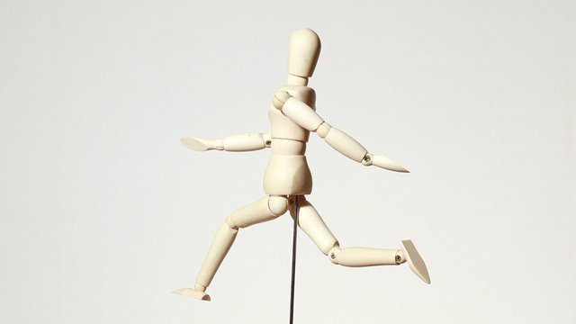 rotating wooden figure of running man