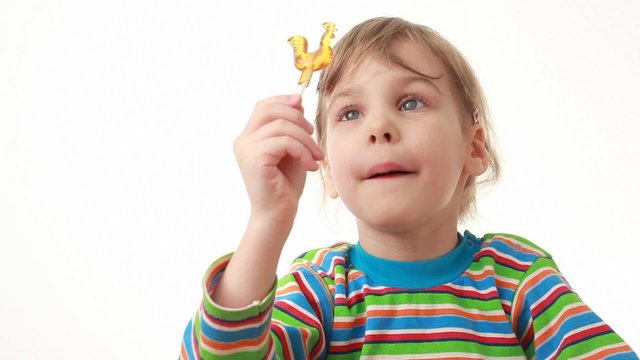 Little Girl Eating Lollipop In Chicken Form