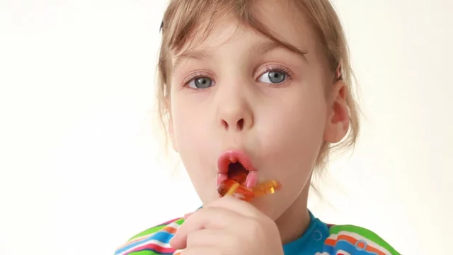 group of little girls licking lollipop little girl licking lollipop in chicken form Stock ビデオ | Adobe Stock