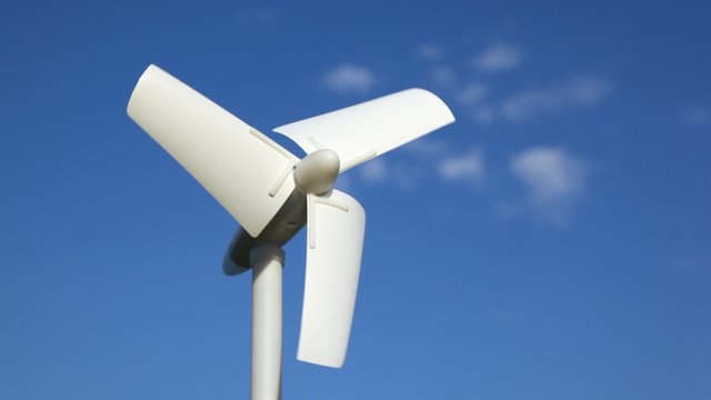 tiny wind driven generator rotating against sky