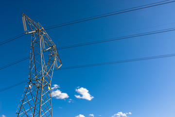 Power pole against a vivid blue sky