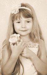 little girl wearing vintage clothes with rose toned sepia image