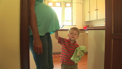 Pregnant mother and young toddler son sharing time together