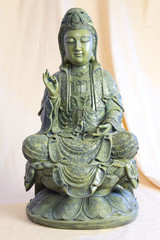 Fototapeta premium Bronze figure of sitting and meditating Buddha