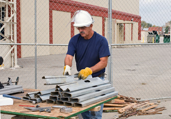 Worker Stacking Metal Studs