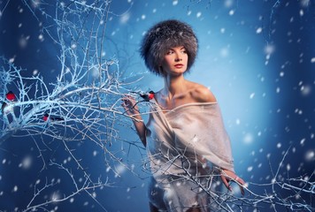 Attractive woman in winter forest