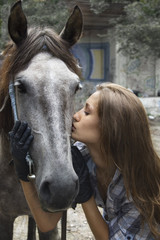 cowgirl kisses her horse
