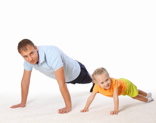 The father and his little daughter doing exercises together.