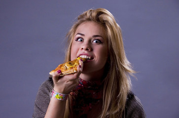 Girl eating delicious pizza.