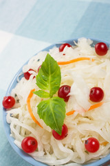 Sauerkraut salad with cranberries, carrot and basil
