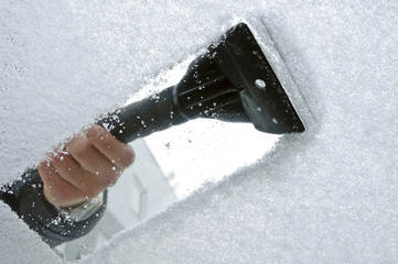 scraping snow and ice from the car windscreen - obrazy, fototapety, plakaty