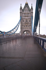 Unusual view of Tower Bridge in London with blurred pedestrians