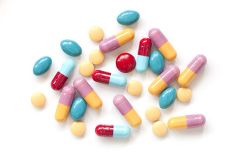 Colorful pill tablets on white background