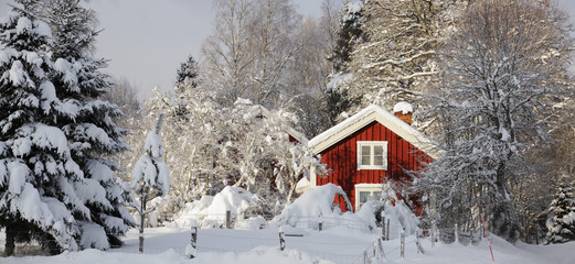 small cottage surrounded by snow and ice