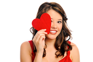 Young woman hides behind heart