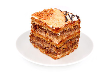 Slice of nut cream cake, isolated on white background
