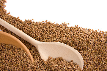 buckwheat and wood spoon isolated on white