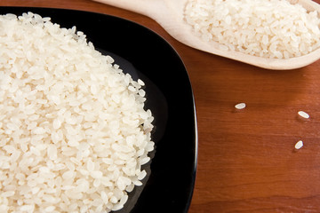 rice and black plate with wooden spoon