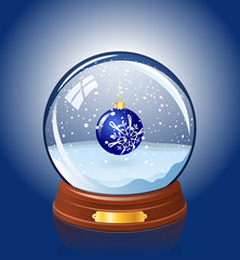 Snowy glass ball with a Christmas-tree decoration within