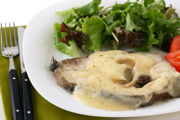 boiled fish with sauce and vegetables