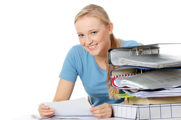 Smiling young woman sitting at the desk