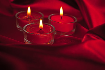 Valentines candles on satin background