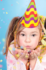 Partygirl pustet Konfetti von der Hand