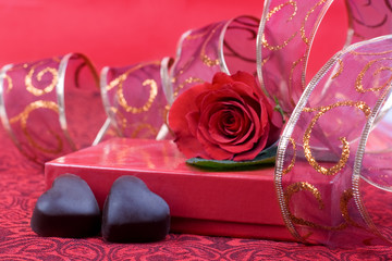 Chocolate hearts, and gift box with ribbon.