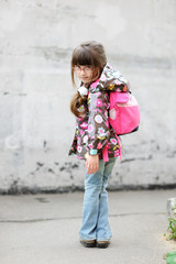 Naklejka premium Adorable preschooler with pink back pack on the way to school