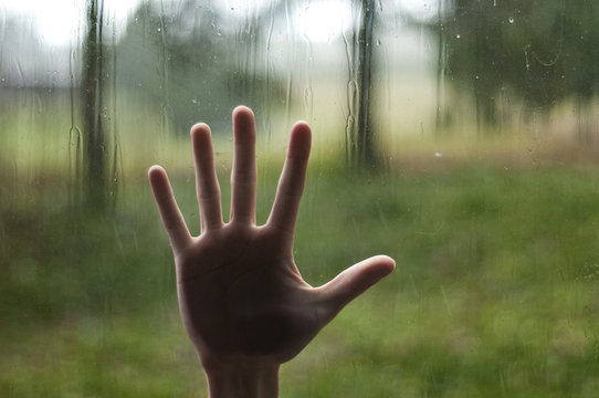 Hand pressing against window
