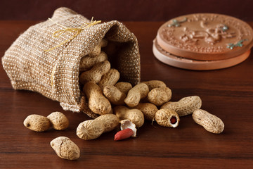 The peanut has dropped out from a bag on a table