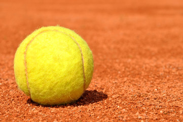 Tennis ball on a tennis clay court