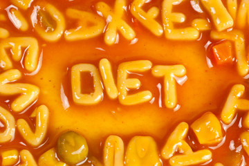 Alphabet shaped pasta forming the word DIET in tomato sauce