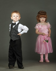The little boy. The little girl costs behind with a flower