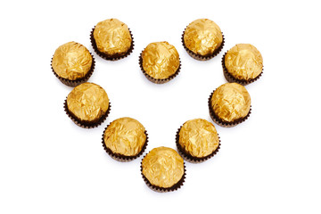 Candy in golden foil in the shape of a heart
