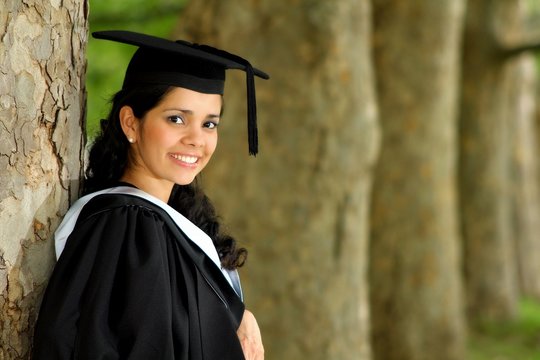 A portrait of a young girl girl in a graduation gown.