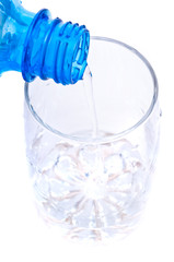 bottle pouring water into  glass