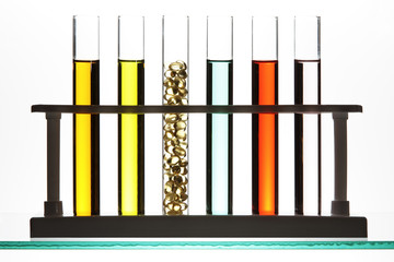 Test tubes filled with colored fluid, and gel cap vitamins