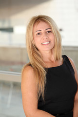 Blond businesswoman standing in hall