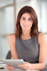 Beautiful businesswoman working on electronic tab