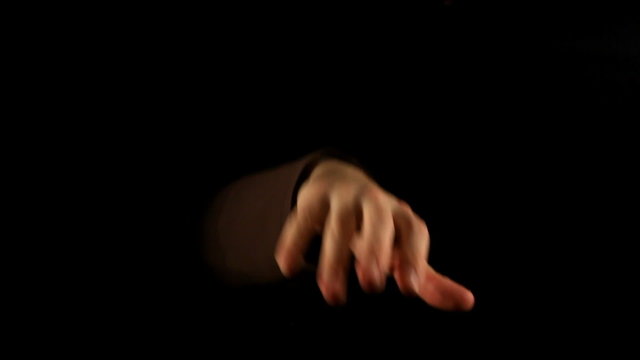 Thumb down gesture on black background
