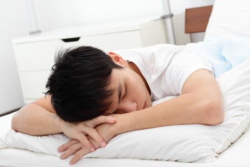 A man sleeping on a bed