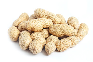 Bunch of whole roasted peanut shells on white background