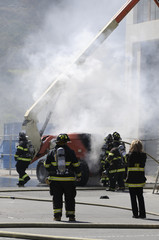 Firefighters extinguishing fire in building,