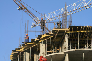 The workers connecting armature on a building site