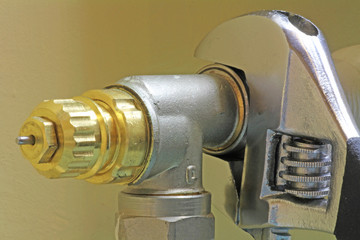 close up wrench on rad valve
