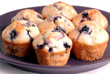 Several blueberry muffins on purple plate