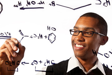 a young man studies a chemistry problem