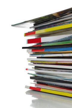 stack of colorful magazine over white background