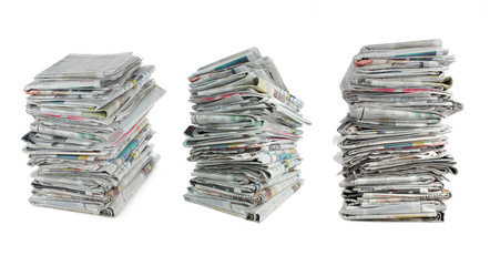 three different angle of stack of newspaper